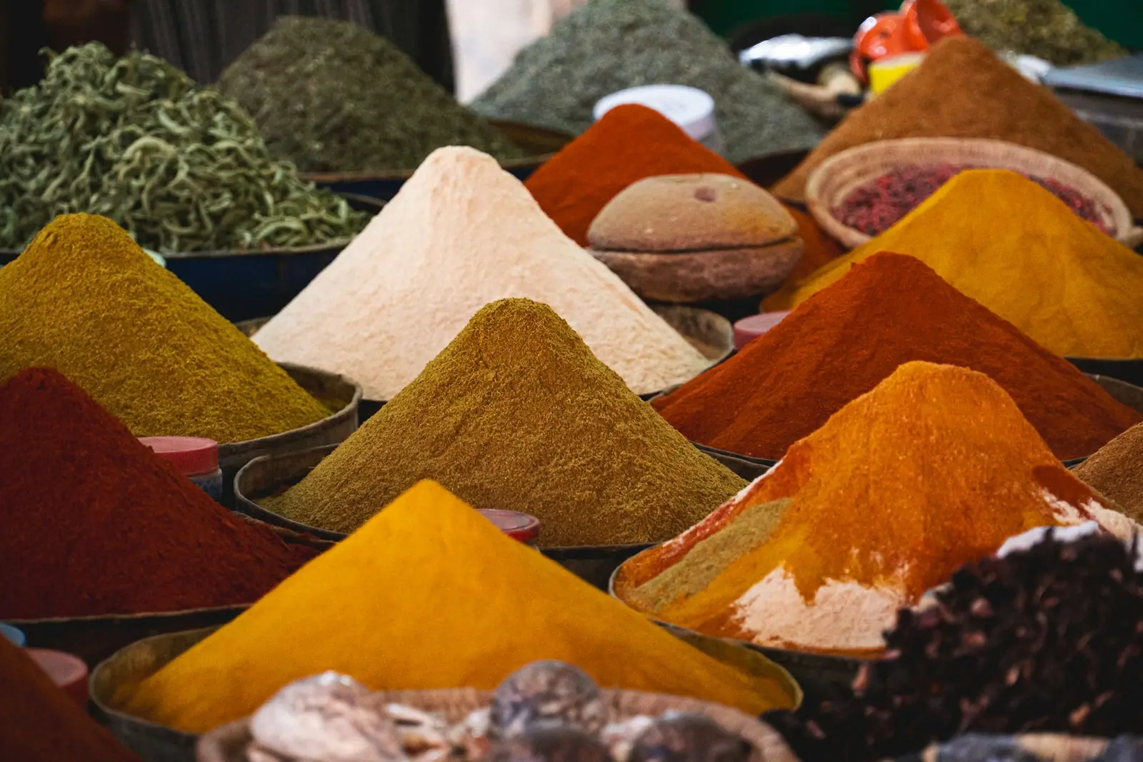 Mounds of ground turmeric, chilli and other spices
